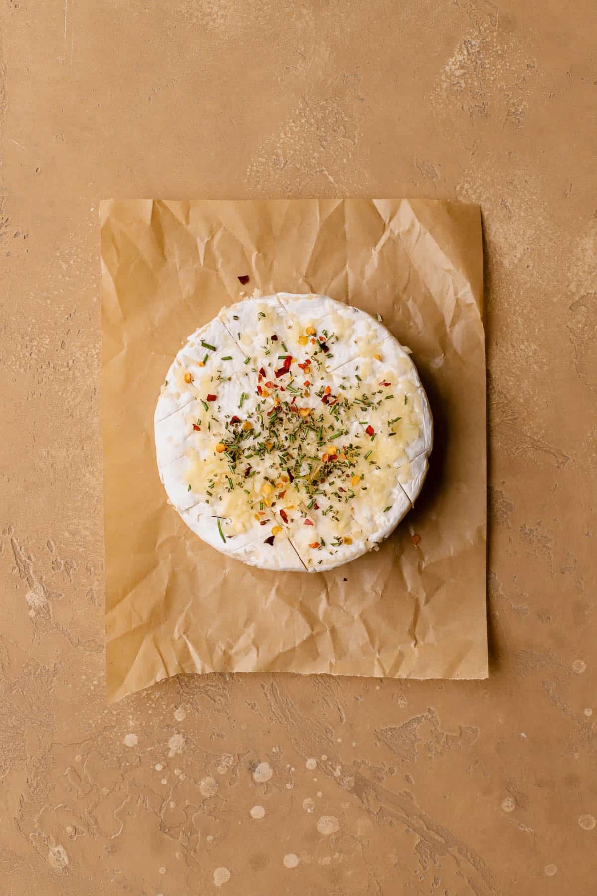 Wheel of brie with garlic, red pepper flakes, honey, salt, pepper, and rosemary. 