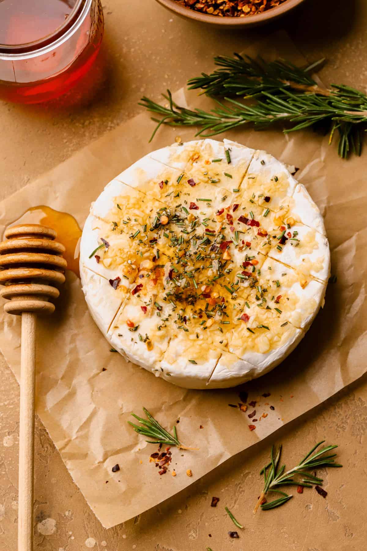 Wheel of brie topped with fresh garlic, rosemary, red pepper flakes, and honey. 
