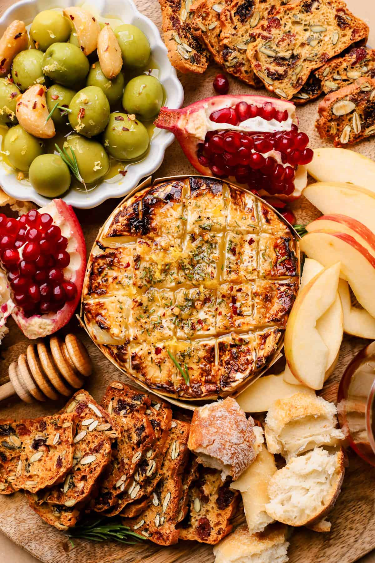 Baked brie with garlic, honey, red pepper flakes, and fresh lemon zest.  Served with olives, pomegranates, crackers, bread, and apples.  