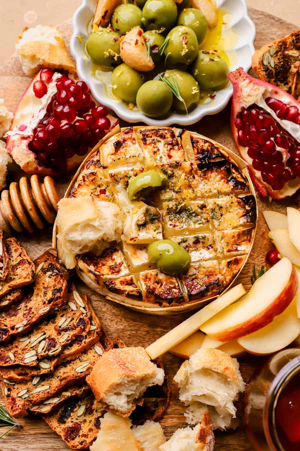 Baked brie with garlic, honey, red pepper flakes, and fresh lemon zest.  Served with olives, pomegranates, crackers, bread, and apples.  