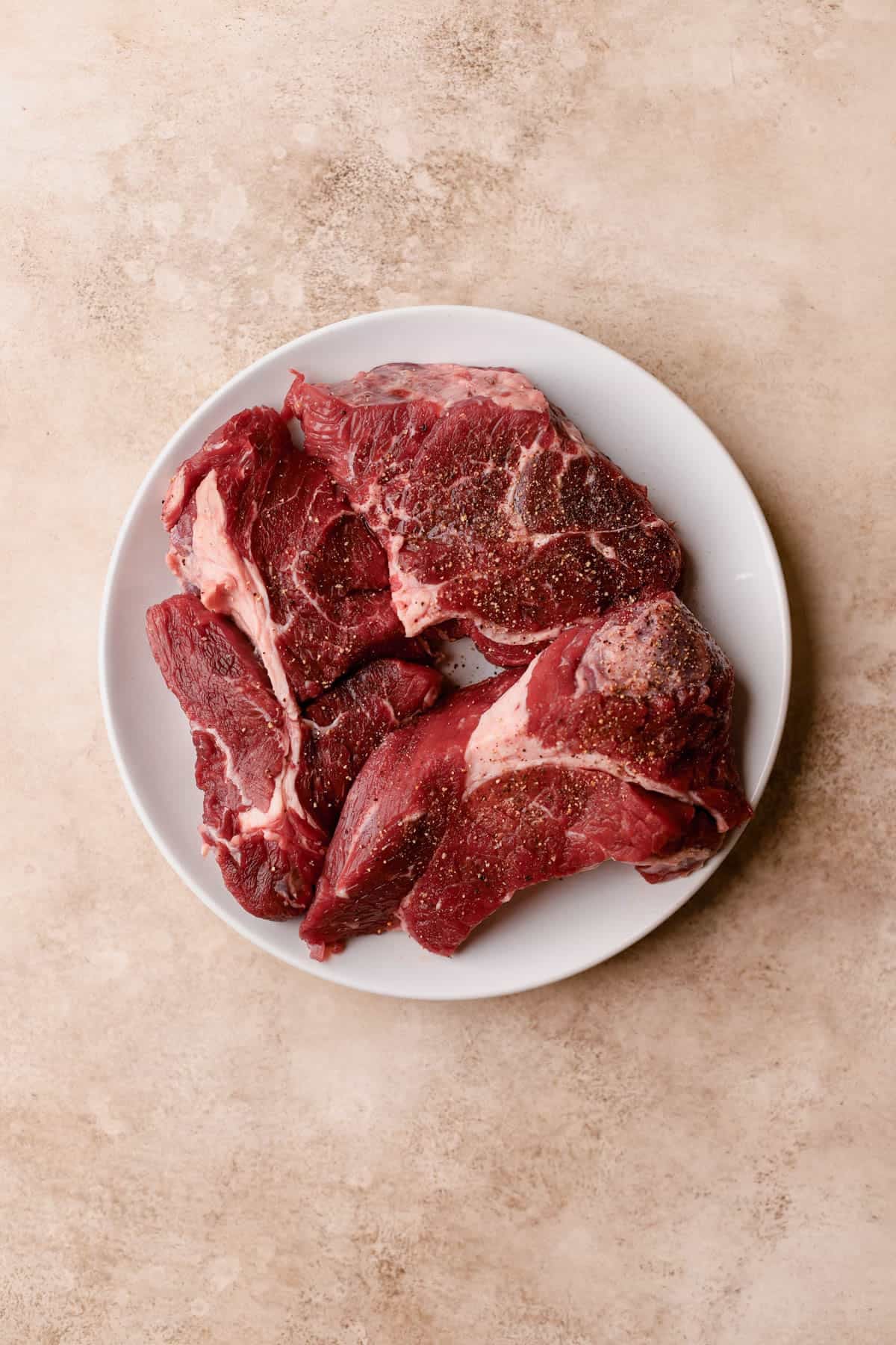 Chuck roast seasoned with salt and pepper.