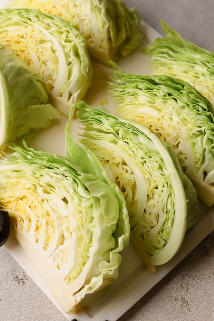 Green cabbage cut into eight wedges. 