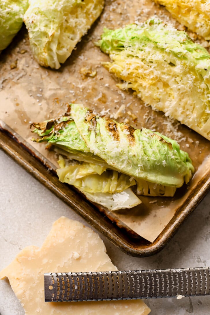 Roasted cabbage wedges sprinkled with parmesan cheese. 