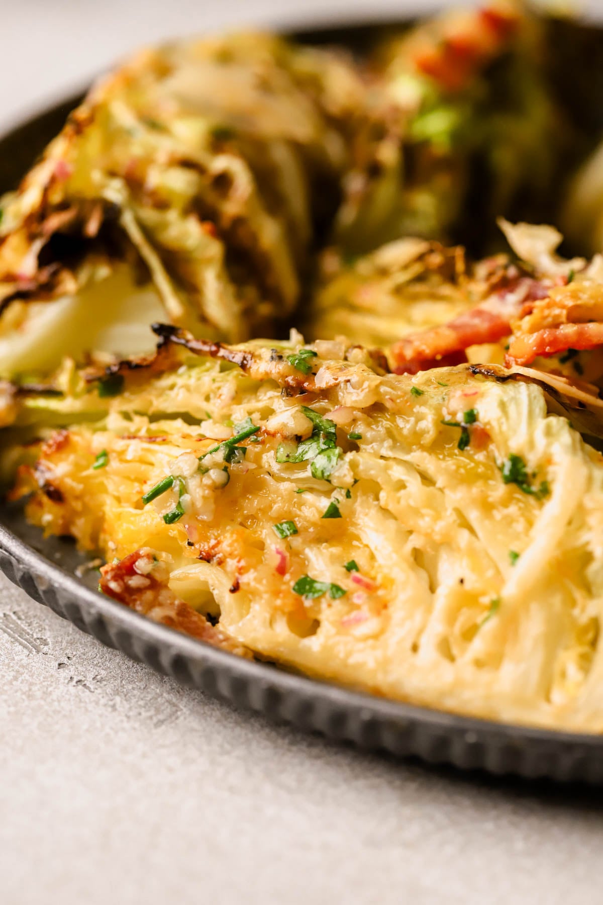 Roasted cabbage salad is made with crispy bacon, parmesan, fresh herbs, and dijon mustard vinaigrette. 