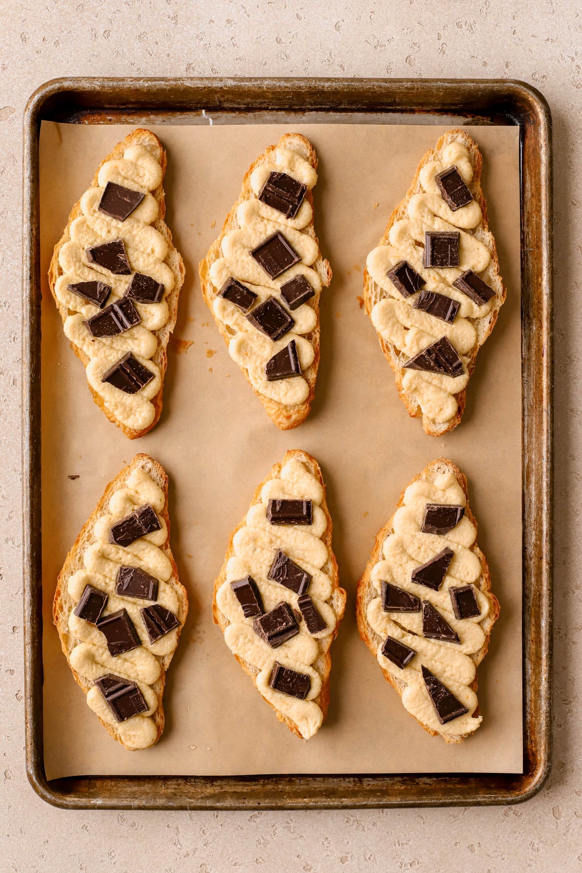 Chopped chocolate sprinkled over frangipane filling. 