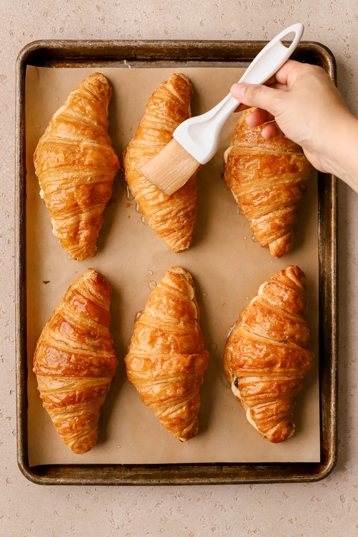 Croissant tops brushed with orange-cardamom syrup.  