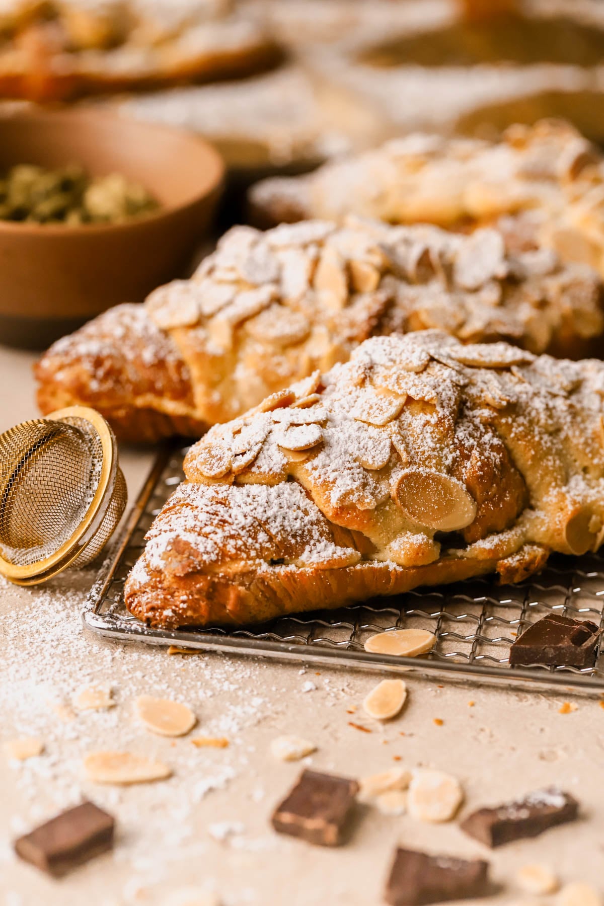 Chocolate almond croissant filled with frangipane and melted chocolate, topped with sliced almonds and powdered sugar. 