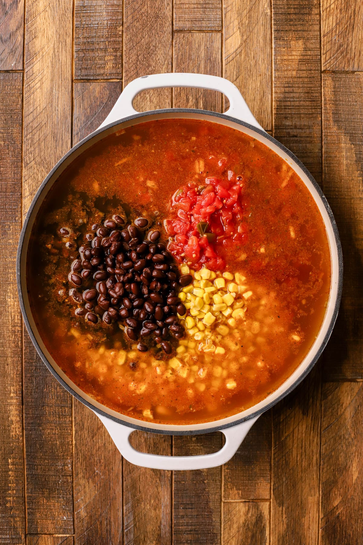 Chicken broth, rotel tomatoes with green chilies, black beans, and corn. 
