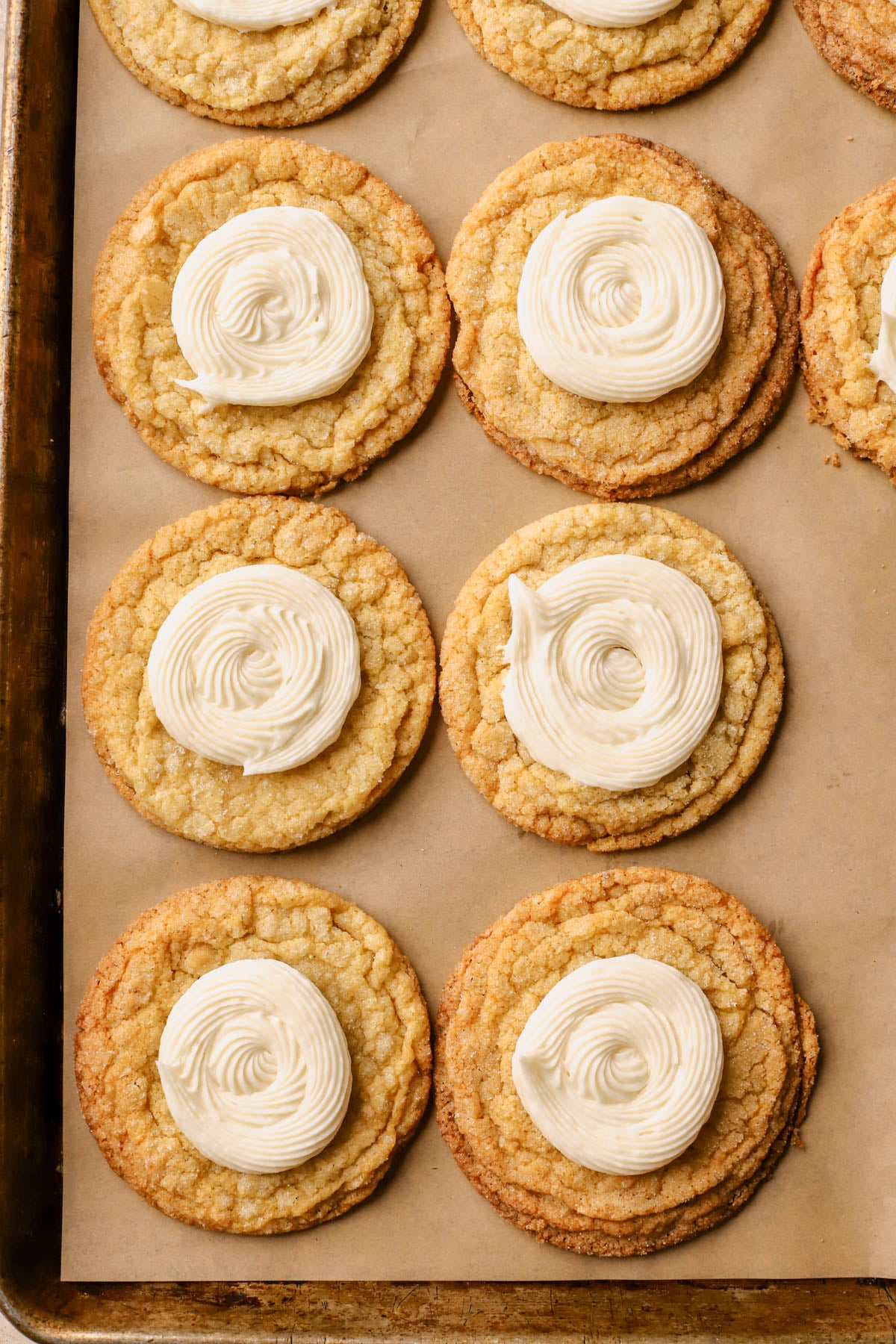 Honey buttercream frosting piped onto cooled cookies. 