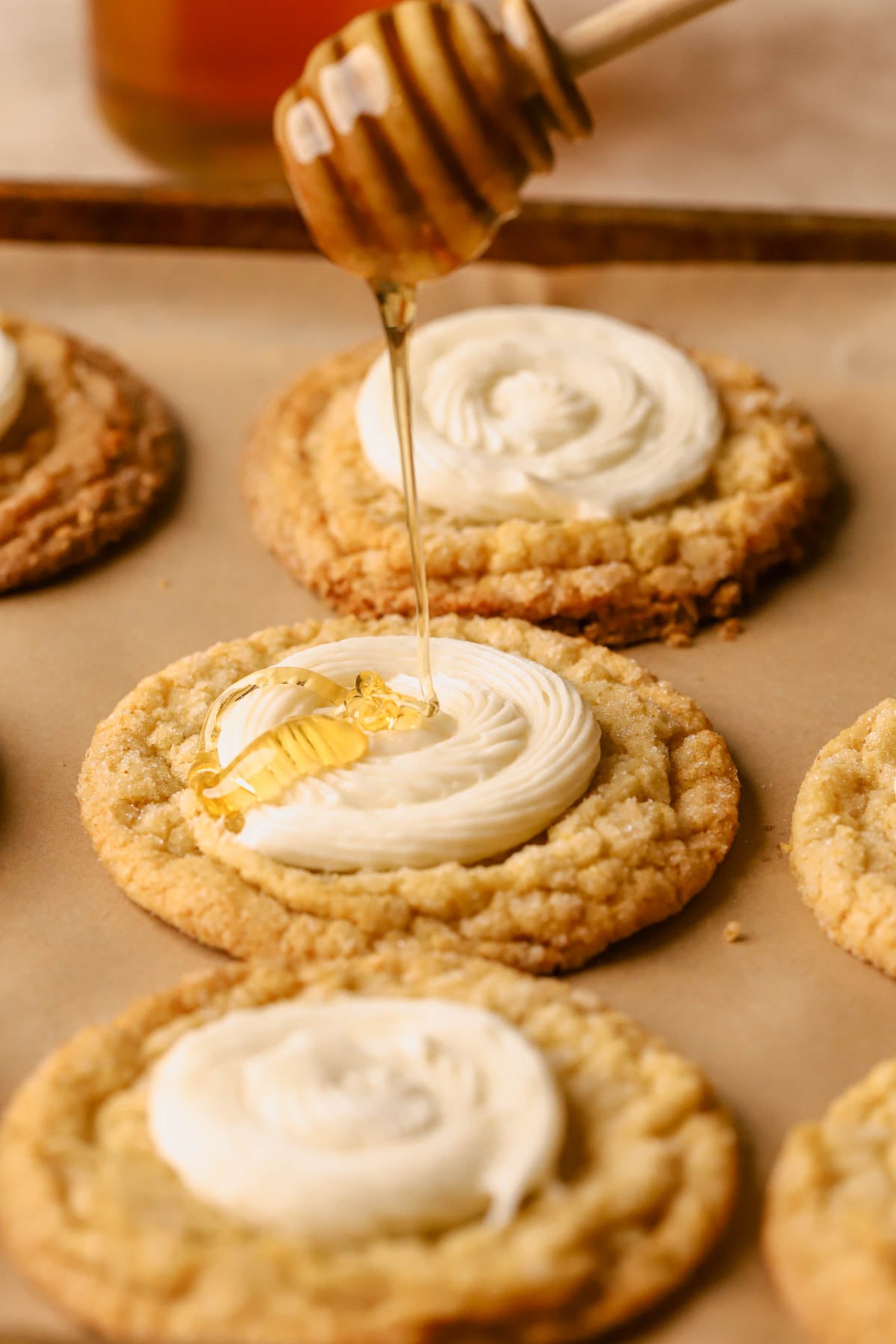 Cornbread cookies swirled with honey buttercream and drizzled with honey.