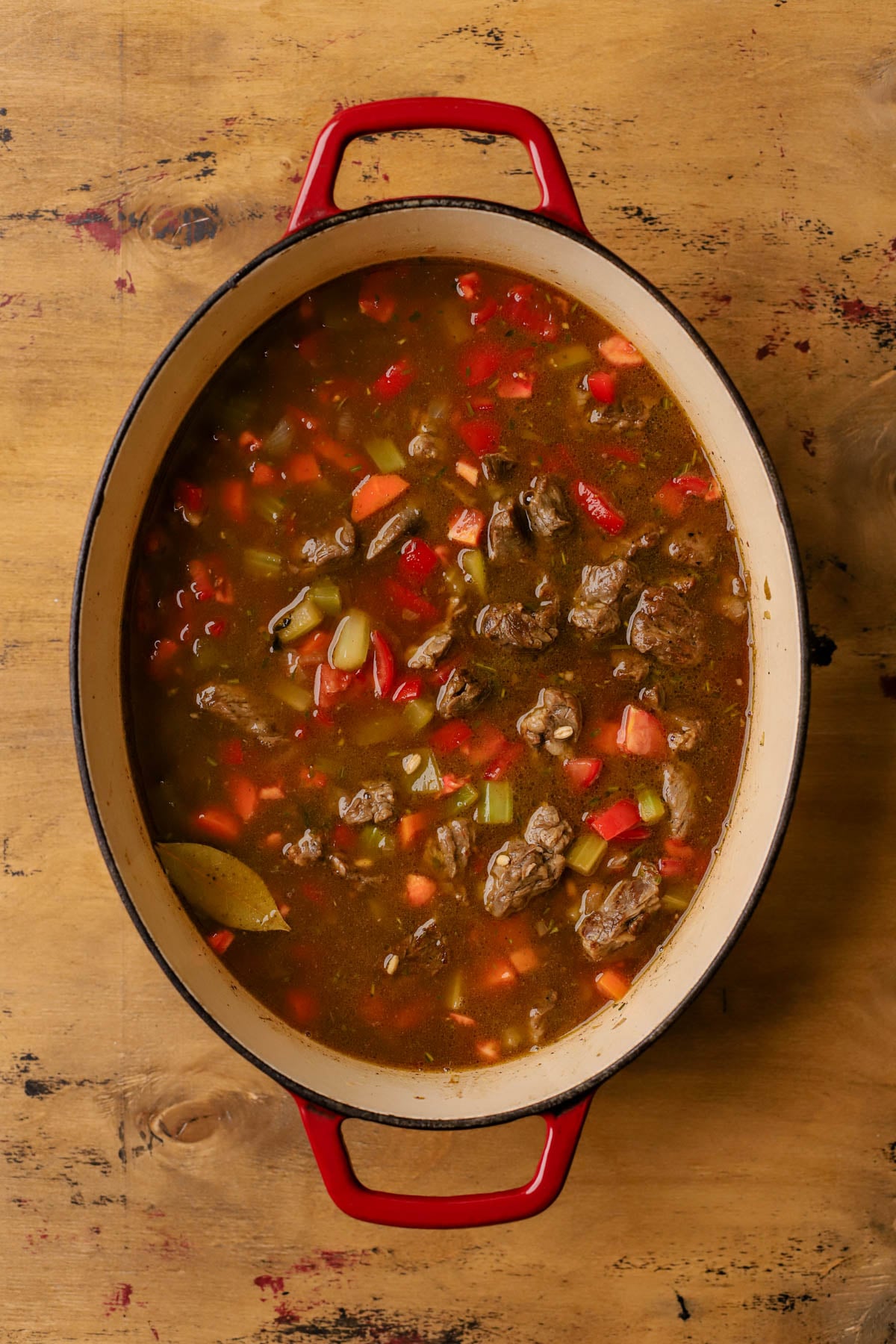 Beef broth added to the dutch-oven. 