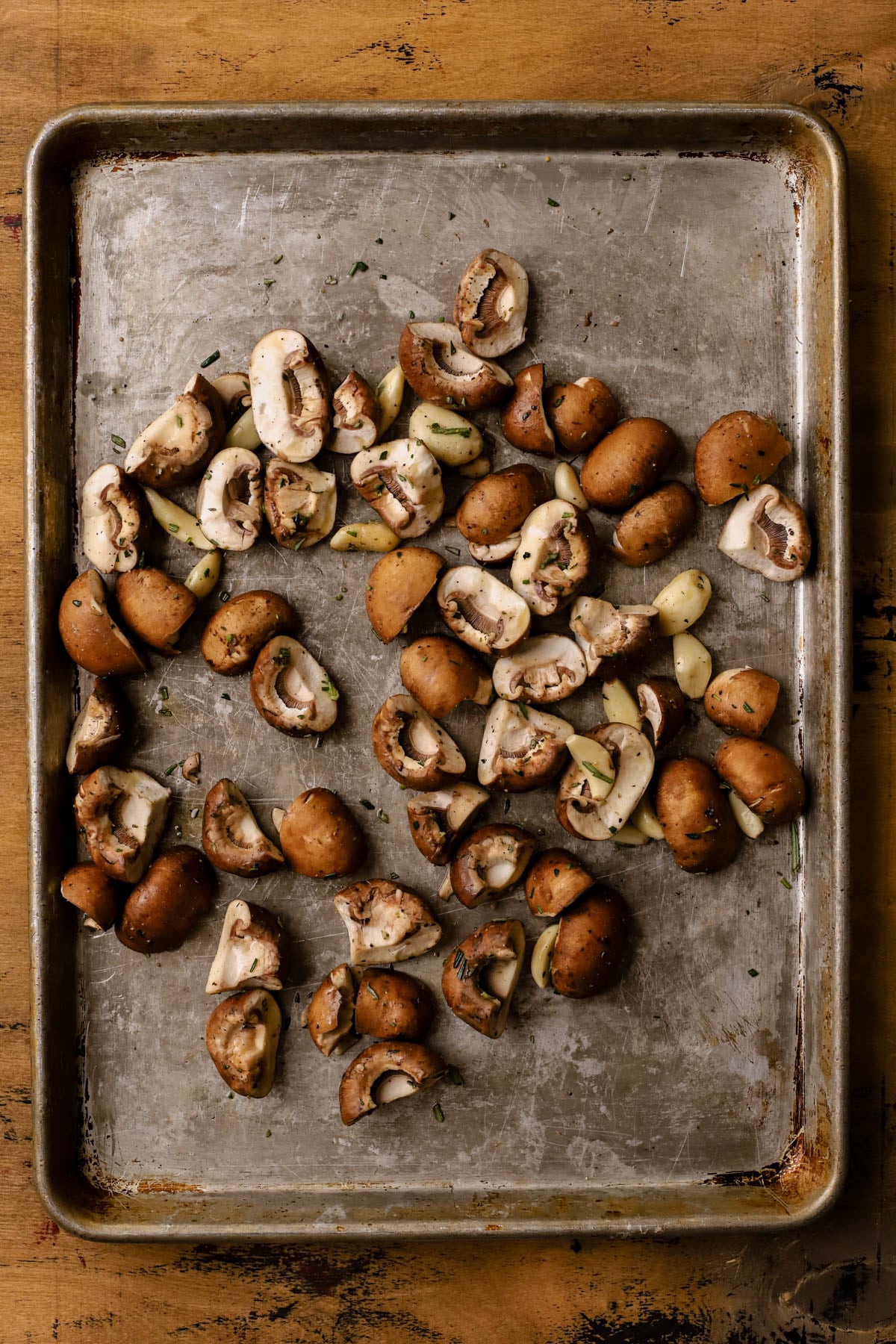 Raw cremini mushrooms tossed with butter, rosemary, and whole garlic cloves. 